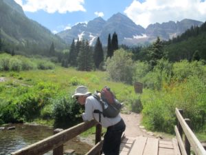 Contemplating a babbling brook in Maroon Bells